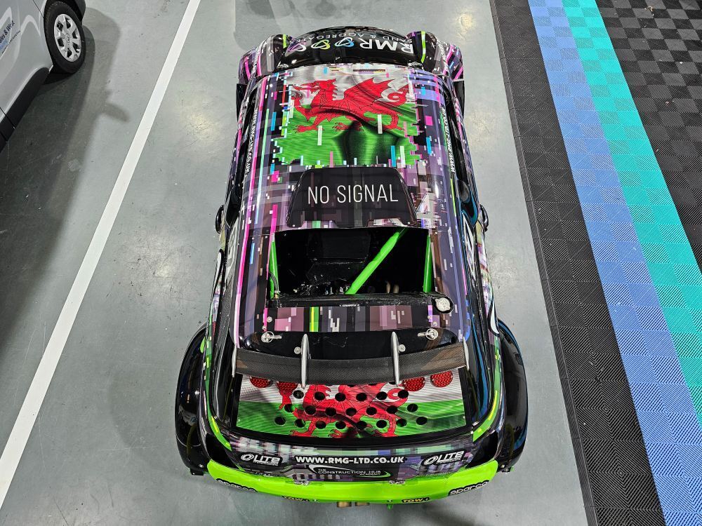Aerial view of colourful motorsport livery and graphics on Mini Cooper V6 rally car