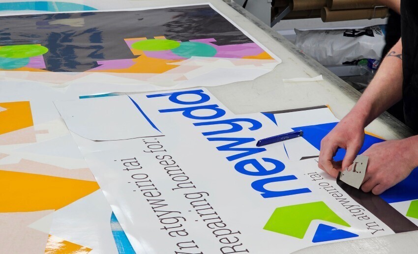 Van wrap installer preparing graphics for installation