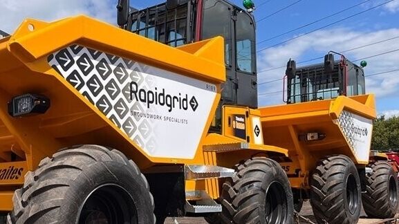 Two identical Thwaites site dumpers showing identical templated graphic kits for fleet brand continuity.