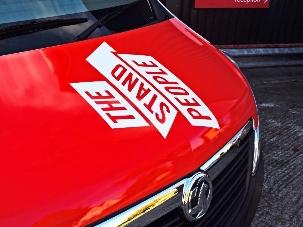 White company branded vinyl graphics on bonnet of red Vauxhall Movano Box van.