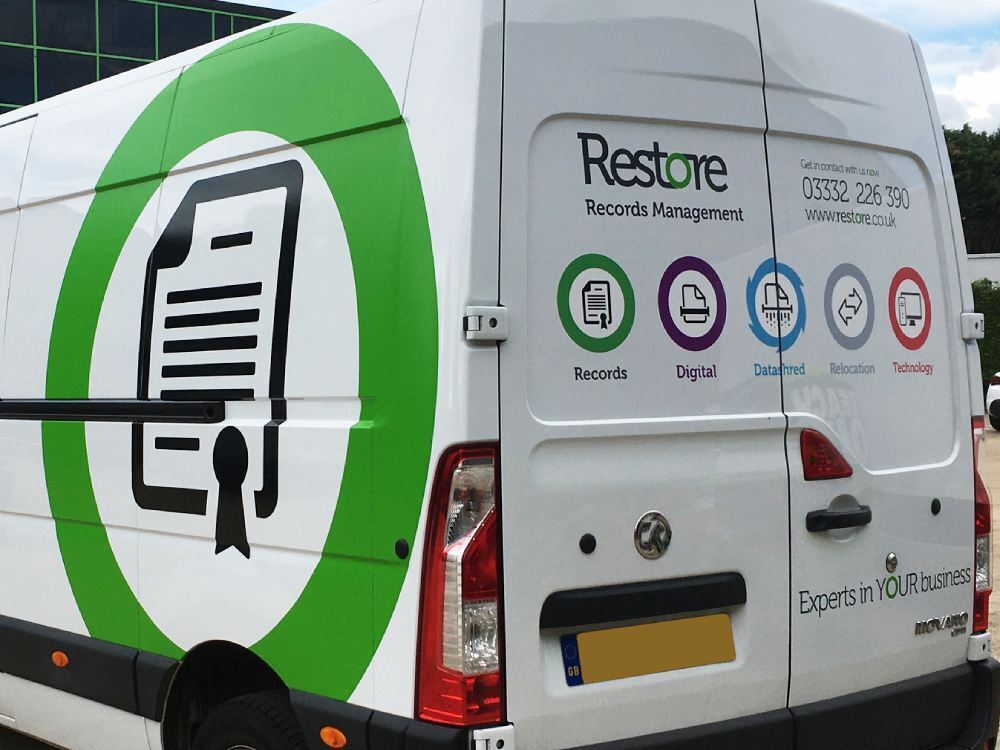 Various vinyl graphics on a white company van.