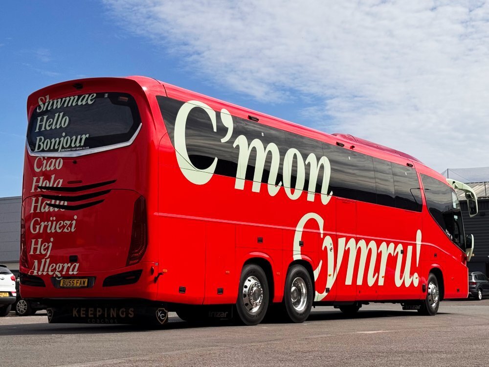 Red branded vinyl vehicle wrap on FAW national Welsh football team luxury coach.
