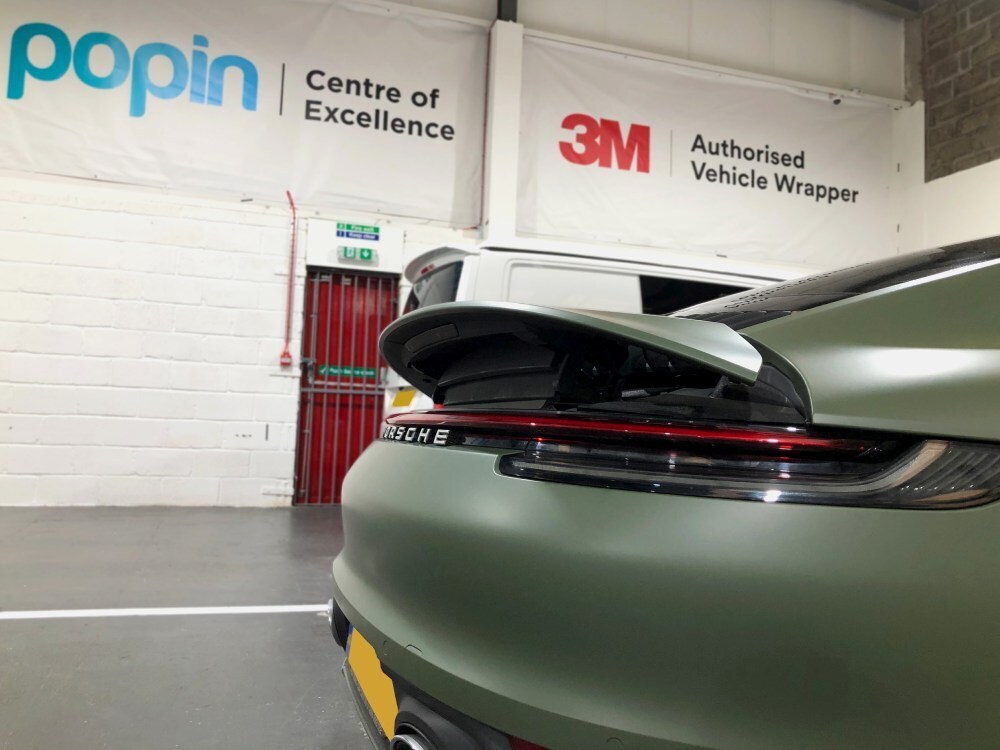 Back end of Porsche 911 with khaki green matte motorsport livery
