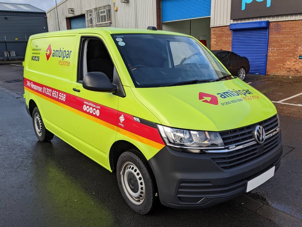 Bright yellow Ambipar Response van wrap on Volkswagen Transporter.