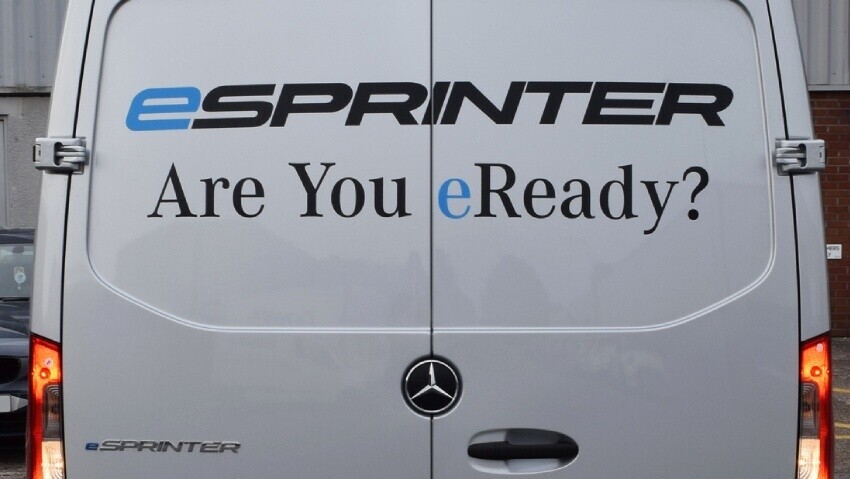 Mercedes-Benz E-Sprinter with rear vinyl graphics displaying pro-electric vehicle message.