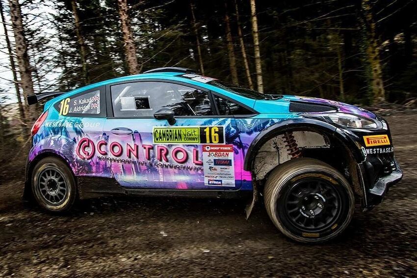 Sponsor vinyl graphics installed on motorsport race car.