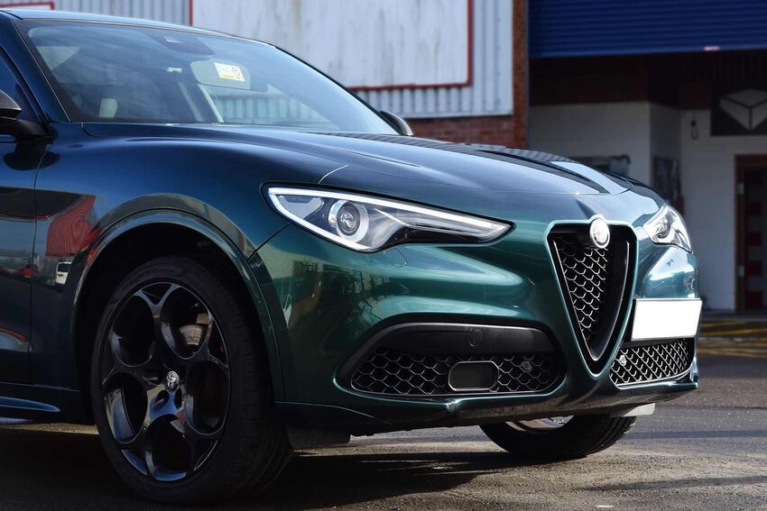 Paint protection wrap film installed on a green Alfa Romeo Stelvio vehicle.