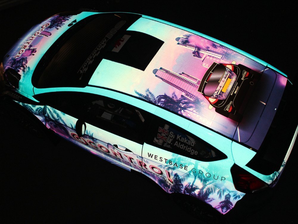 Reflective vehicle wrap on a company car.