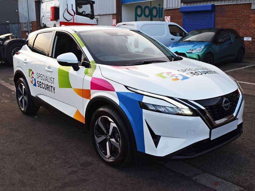 Nissan Juke e-POWER electric company car with branded vehicle graphics outside Popin in Cardiff.