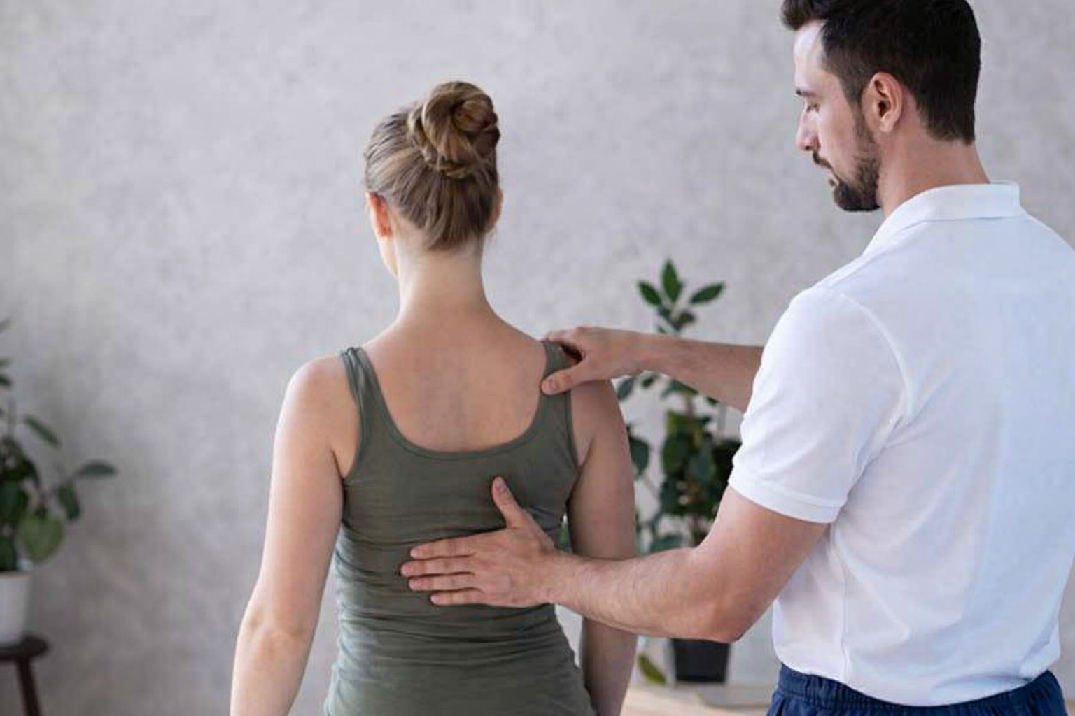 Physiotherapist assessing posture after spinal decompression surgery