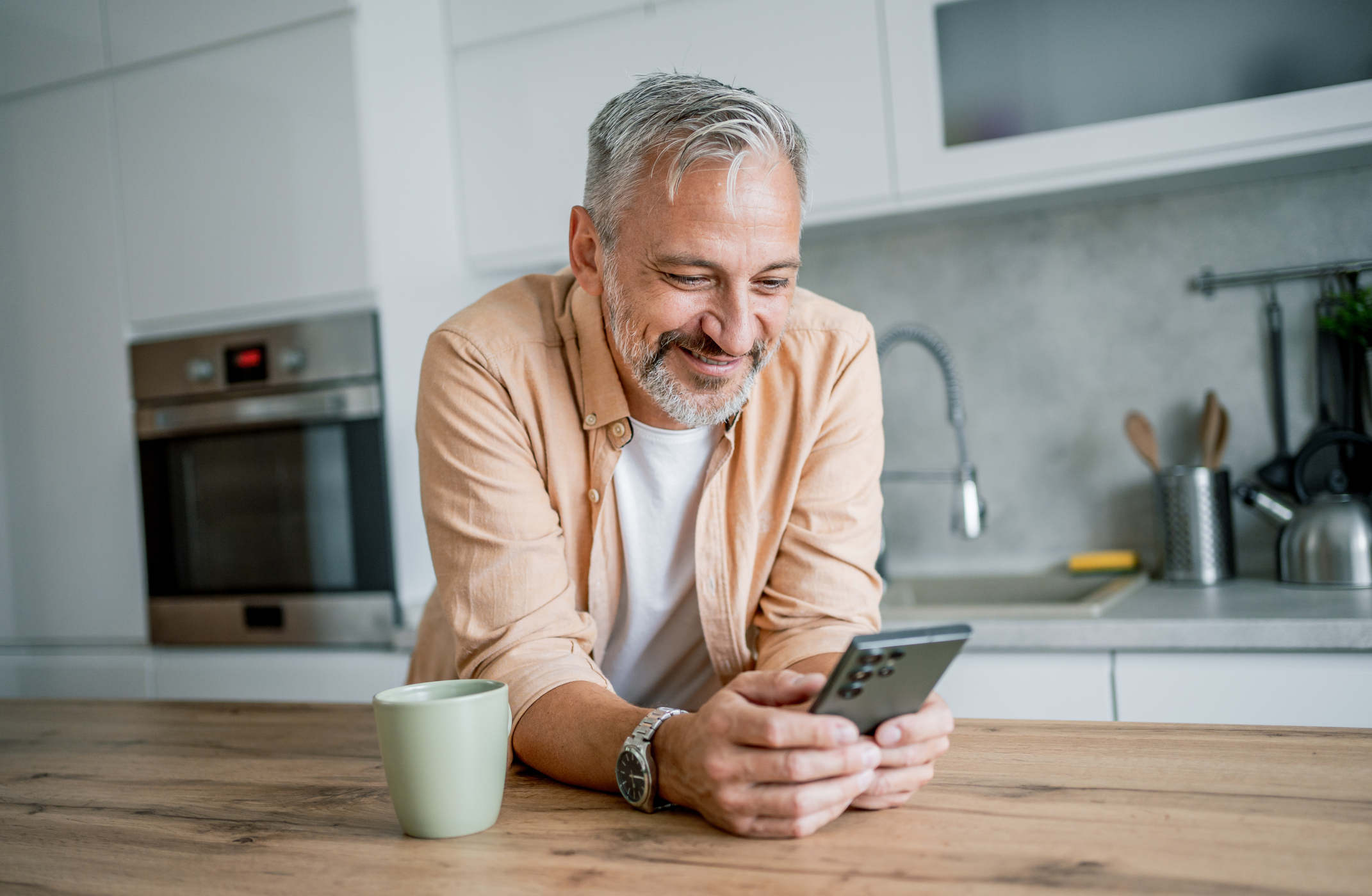 Man comparing health insurance renewal options on his phone