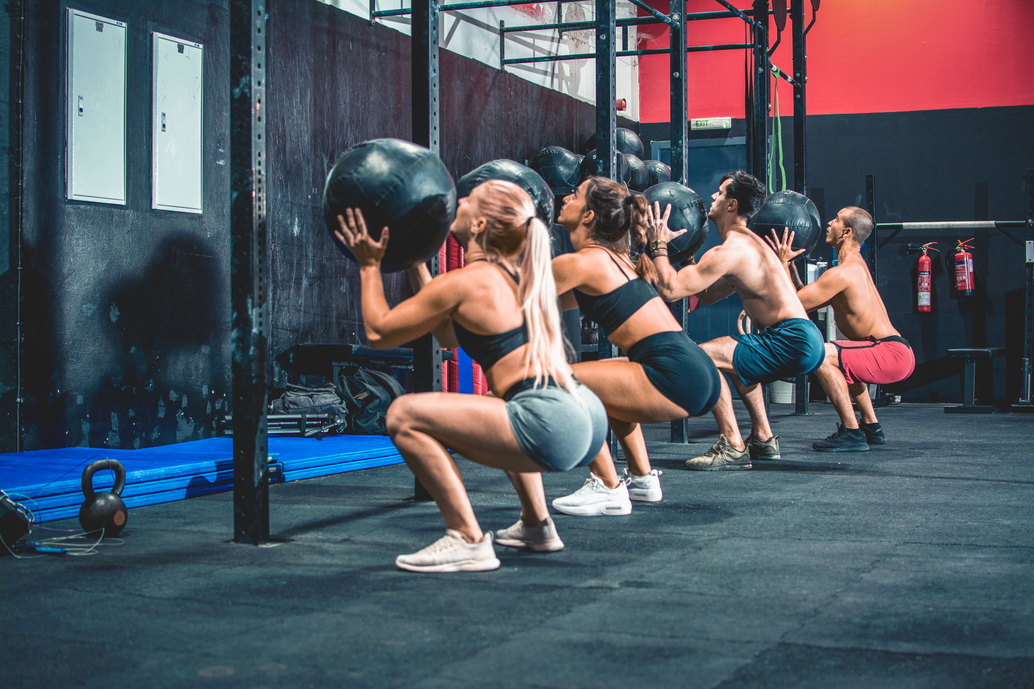 Person training with a wall ball in a gym
