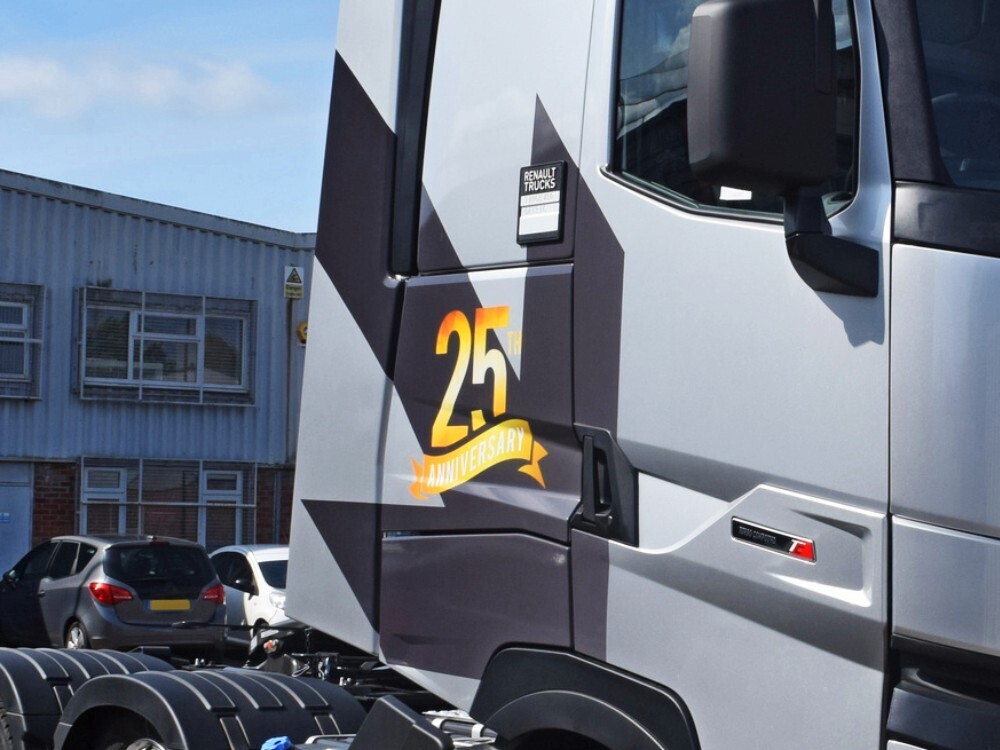 Vinyl graphics newly installed on a silver Renault lorry cab.