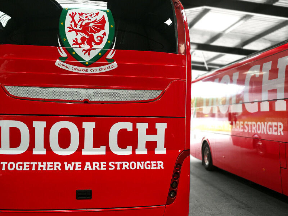 FA Wales branded vehicle graphics on fleet of red Caetano Levante coaches.