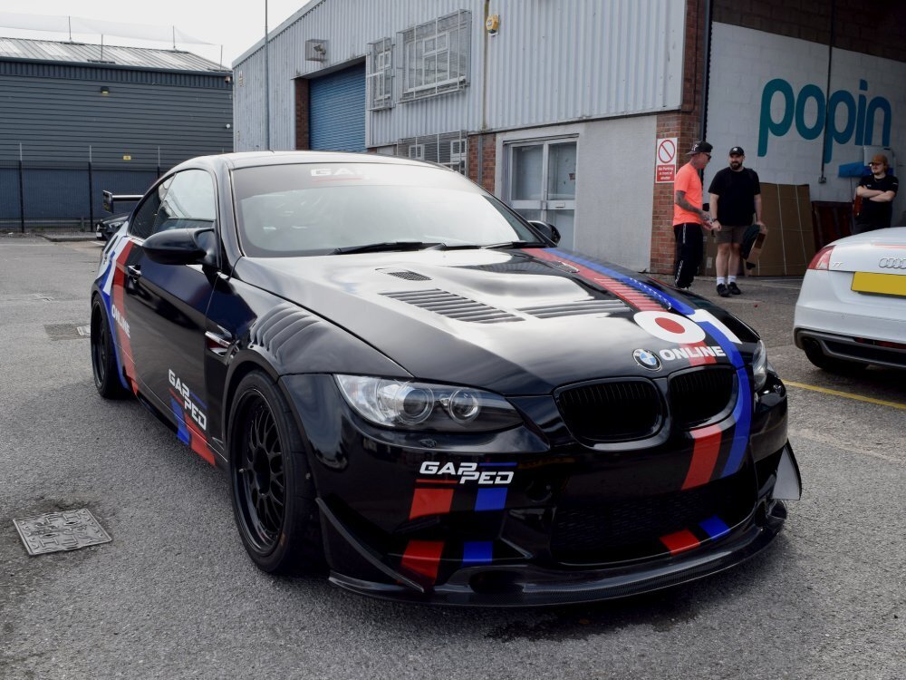 Motorsport wrap and graphics on a black BMW E92 M3 race car