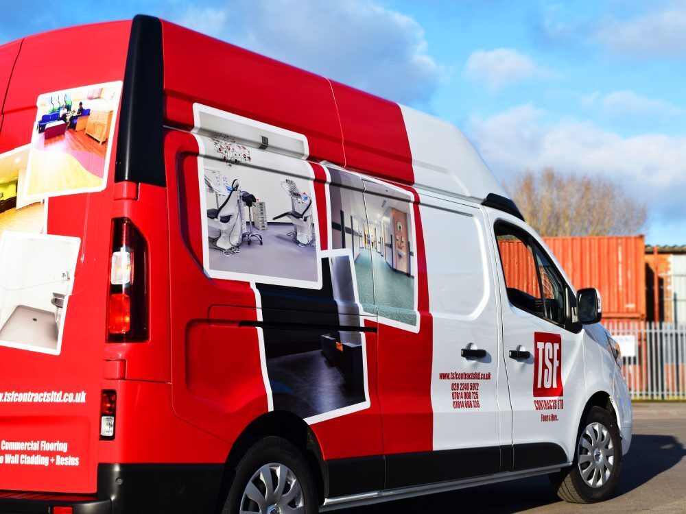 Red branded partial van wrap on a Nissan Primastar.