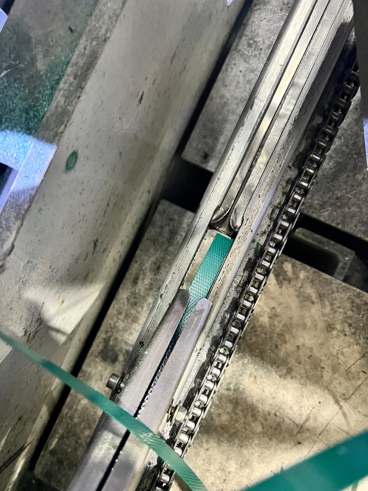 Small burr in the chute assembly disrupting strap path and causing repeated feeding issues