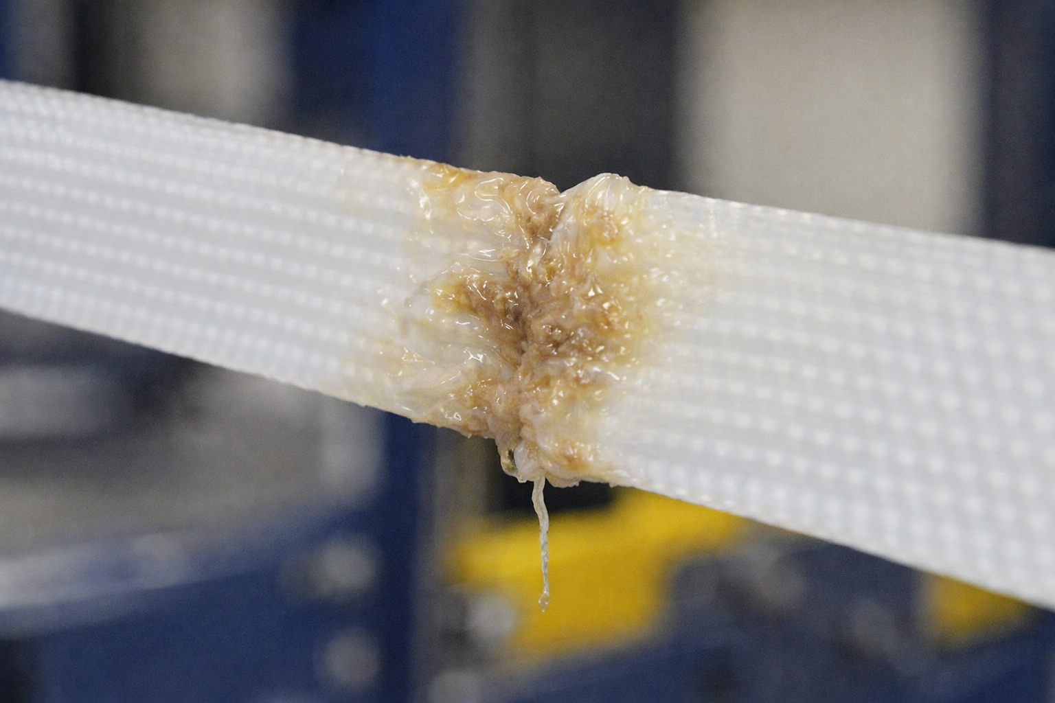 Melted or deformed strap caused by incorrect weld time or temperature on a strapping machine