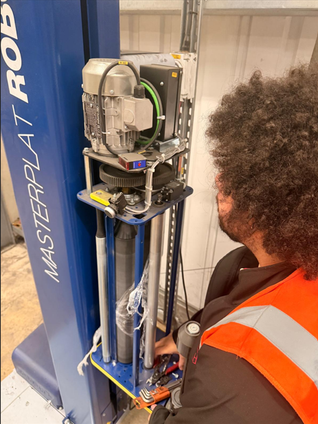 Engineer inspecting pallet wrapping equipment