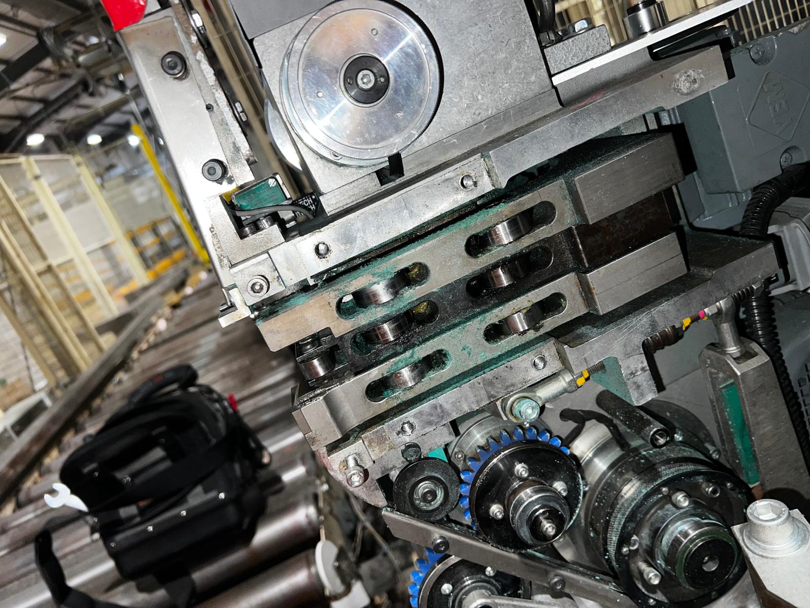 Strap dust build-up around feed rollers and drive components on a strapping machine