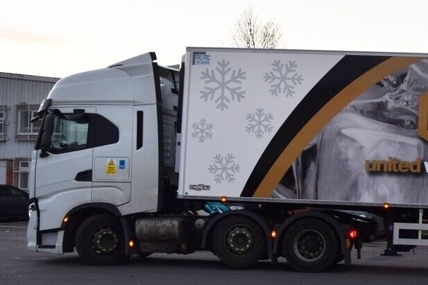 Snowflake vehicle vinyl graphics on business truck for winter seasonal promotional campaign.