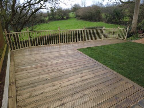 A wooden decked area looking out over the country side

