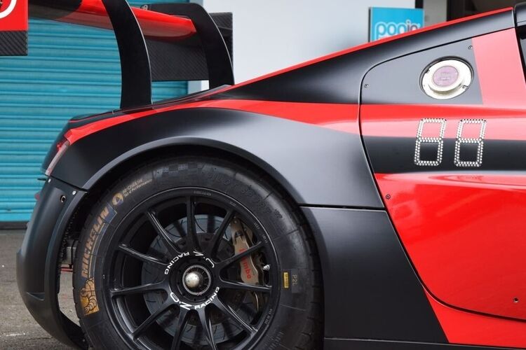 Black matte with red gloss motorsport wrap on an Audi race car.