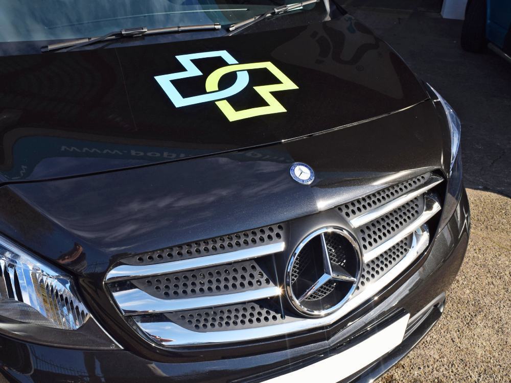 Branded vinyl van graphics on front bonnet of company Mercedes Citan.