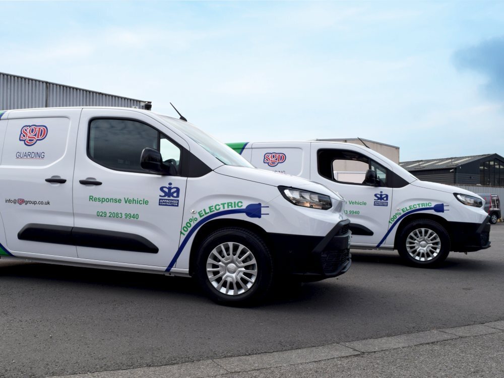 Two white Toyota Proace company vans with matching vinyl graphics.