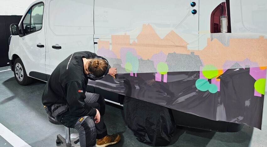 Branded van wrap and graphics being installed onto a Renault Trafic.