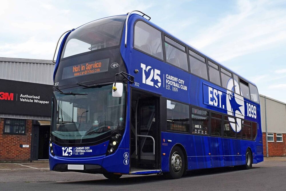 Alexander Dennis Enviro 400 double decker bus with a blue Cardiff City FC vehicle wrap and white vinyl graphics outside Popin.