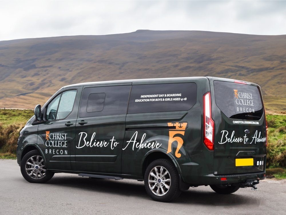 Full company vehicle wrap on Ford Transit Custom van in mountain scenery.