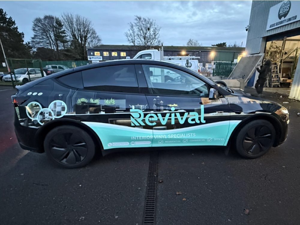 Tesla Model Y Juniper company car with full branded vehicle wrap and graphics.