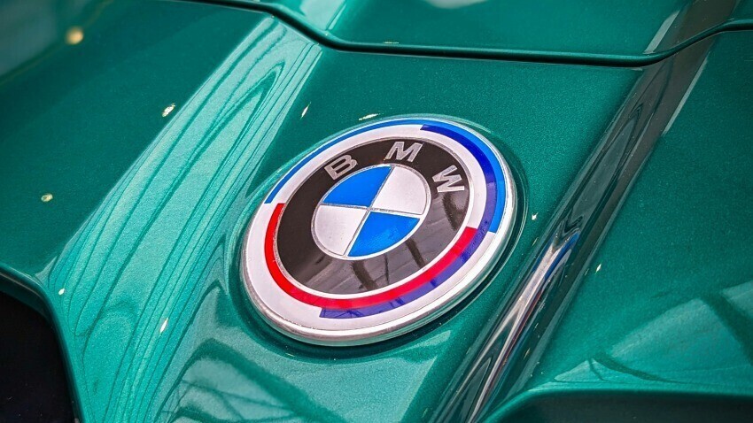 BMW badge on green car.