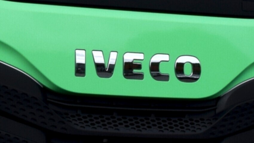 Iveco emblem badge on green truck.