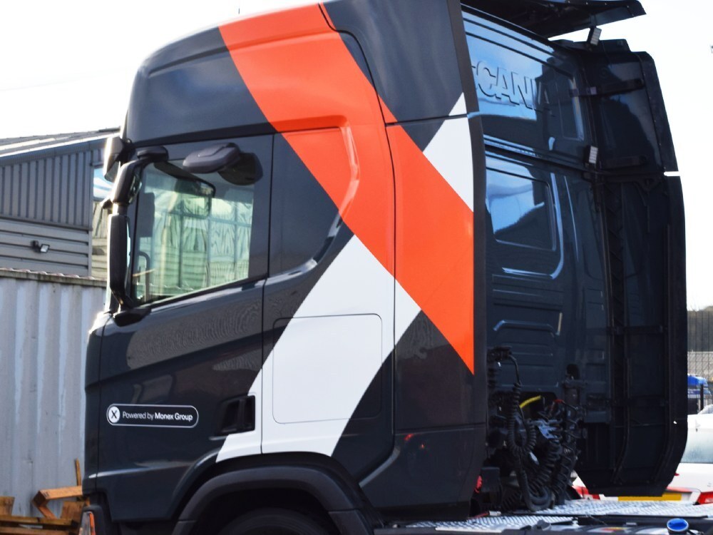 Vinyl graphics on a Scania lorry cab.