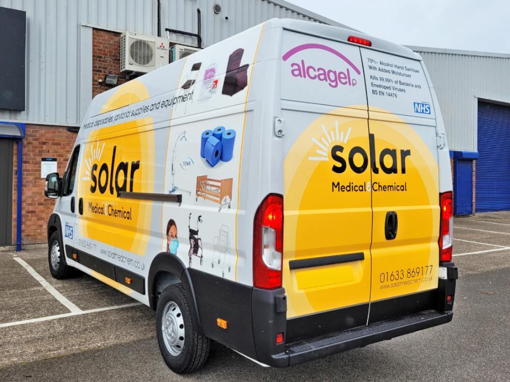 Advertising van wrap on rear end of company Peugeot Boxer vehicle.