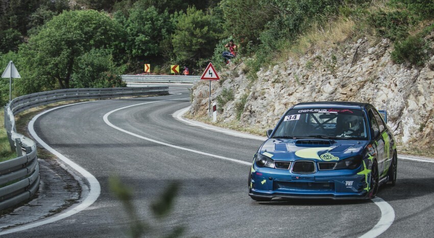 Motorsport livery and graphics on a blue Subaru WRX