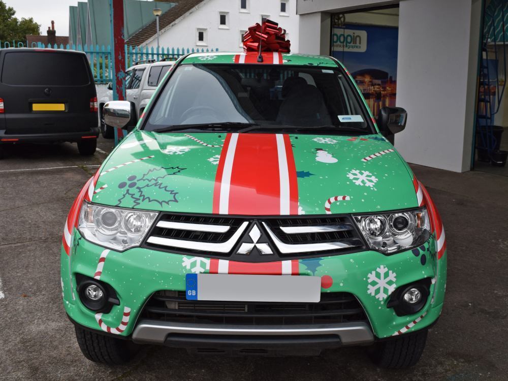 Christmas themed marketing vehicle livery on Mitsubishi L200.