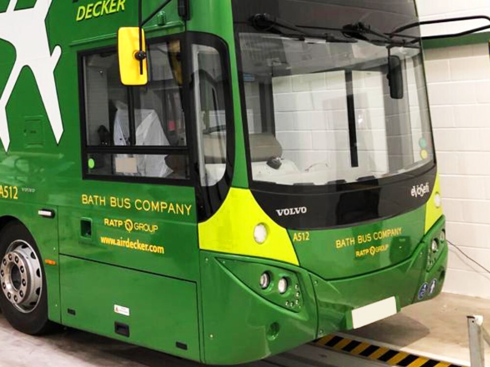 Bath Bus Company green livery with yellow branded vinyl graphics on front of Volvo EvoSeti Air Decker.