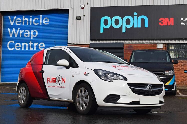 Branded partial vehicle wrap and graphics on white Vauxhall Corsa company car outside Popin in Cardiff.