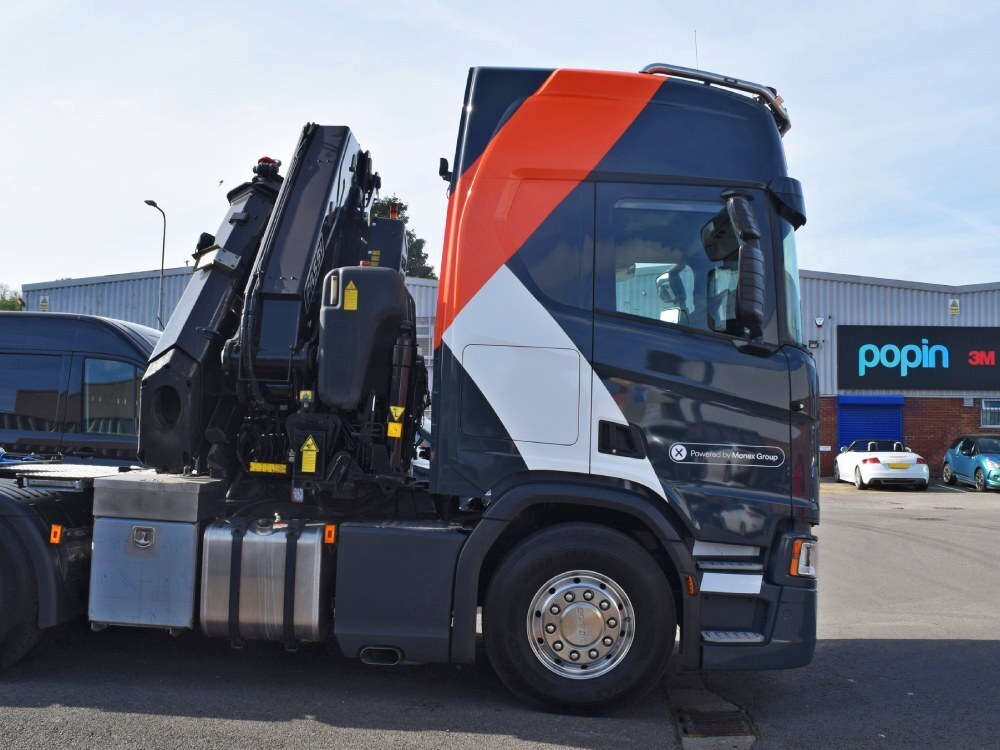 Vehicle wrap and graphics on a Scania lorry cab parked outside Popin in Cardiff.