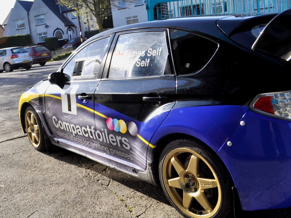 Vibrant motorsport livery on a Subaru Impreza B13 rally car