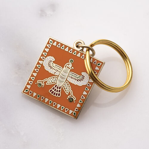 Charm. The Persian Falcon. Orange with 3 Green Stones.