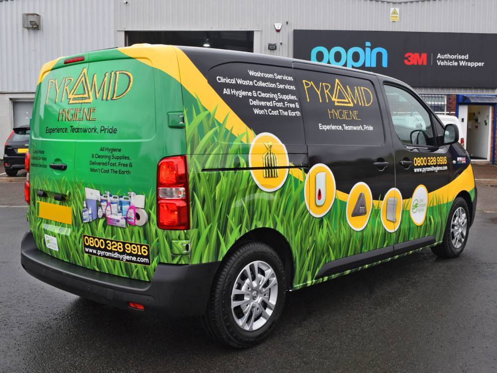 Rear end of company Vauxhall Vivaro van with colourful vehicle wrap outside Popin in Cardiff.