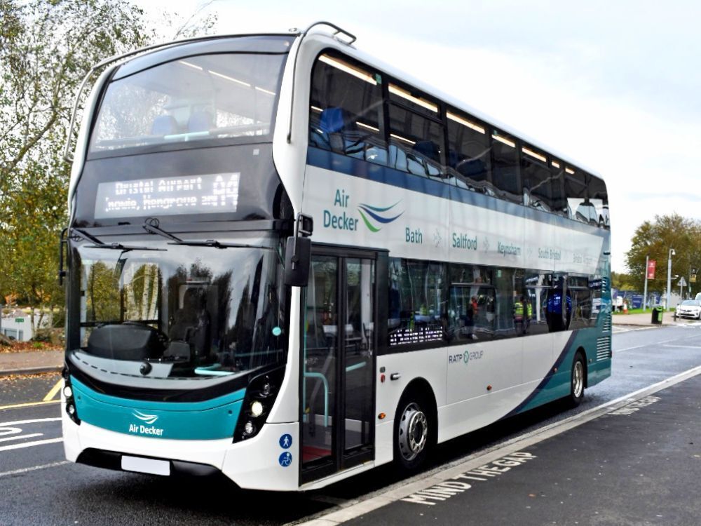 White Volvo EvoSeti with Bath Bus Company partial vehicle wrap and branded vinyl graphics at Bristol Airport.