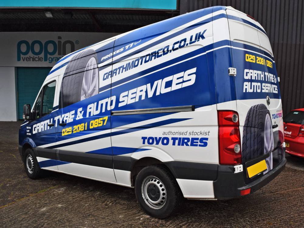 Volkswagen Crafter with blue and white company branded van wrap.