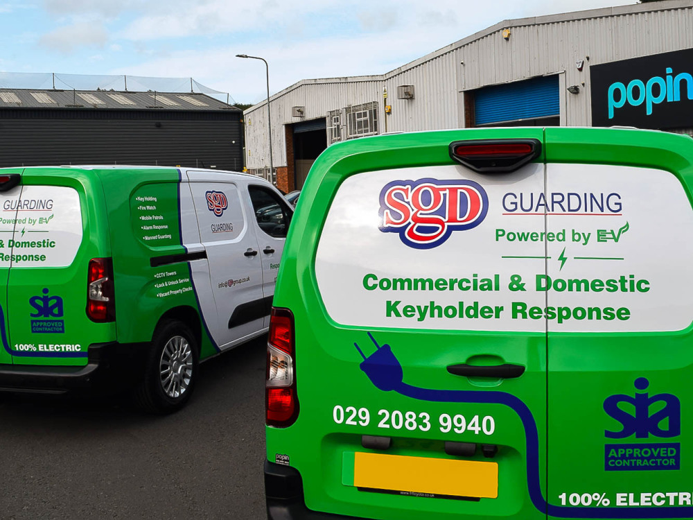 Fleet of Toyota Proace electric vehicles with matching vehicle wraps and graphics for SGD Group outside Popin in Cardiff.