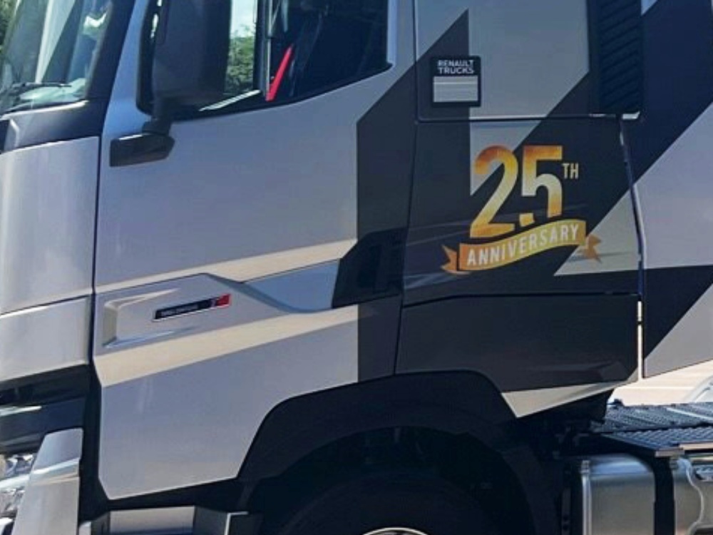 Vinyl graphics installed on the side of a silver Renault lorry cab.