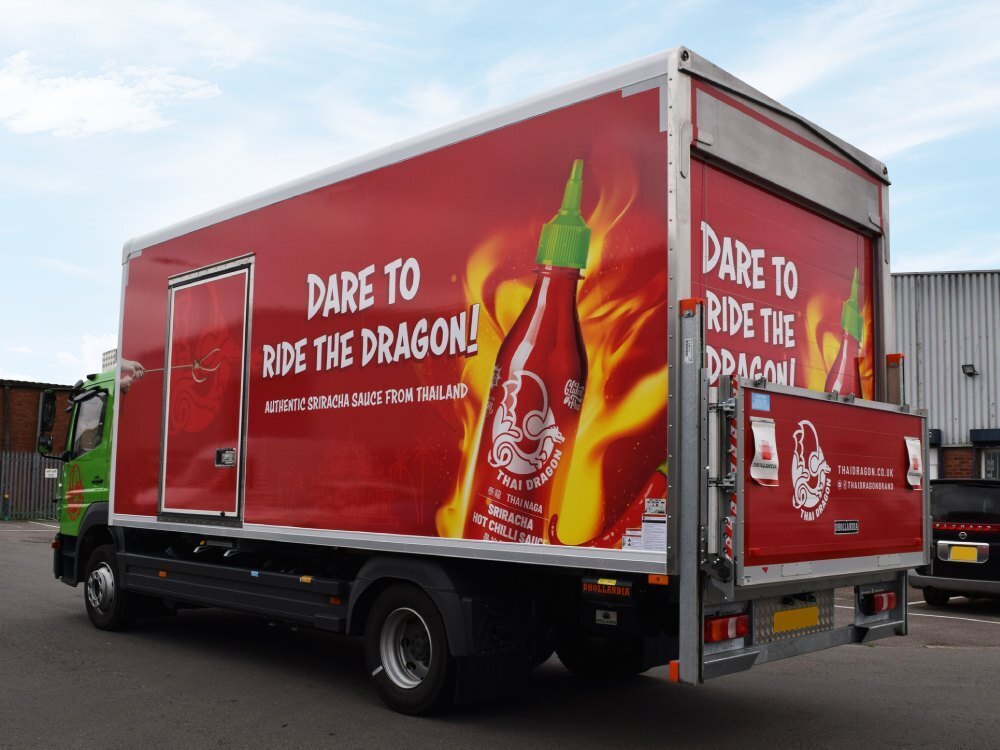 Full advertising wrap on a Mercedes truck.